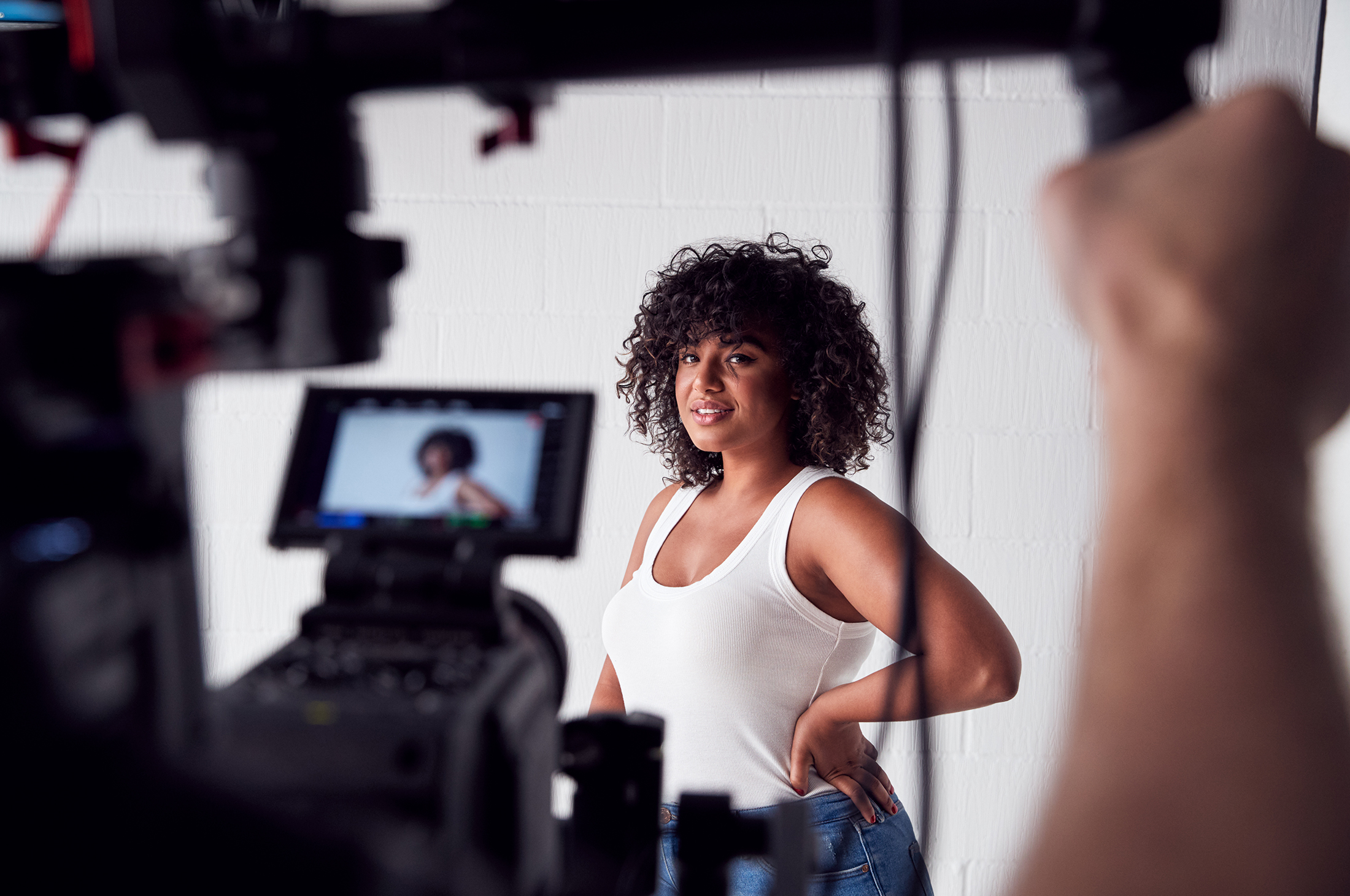 Female Model Posing For Video Camera On Film Set