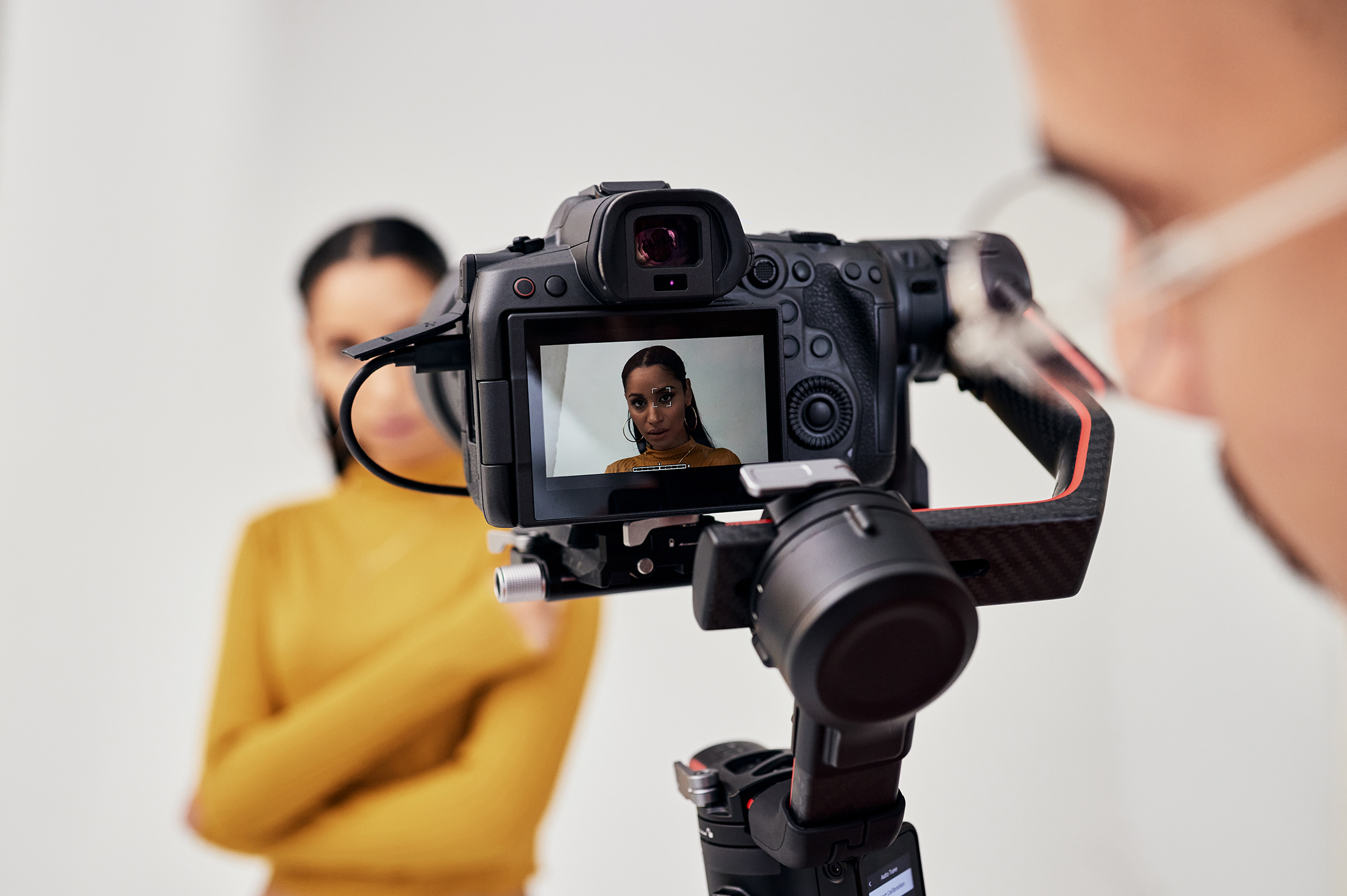 woman in studio being recorded with video camera