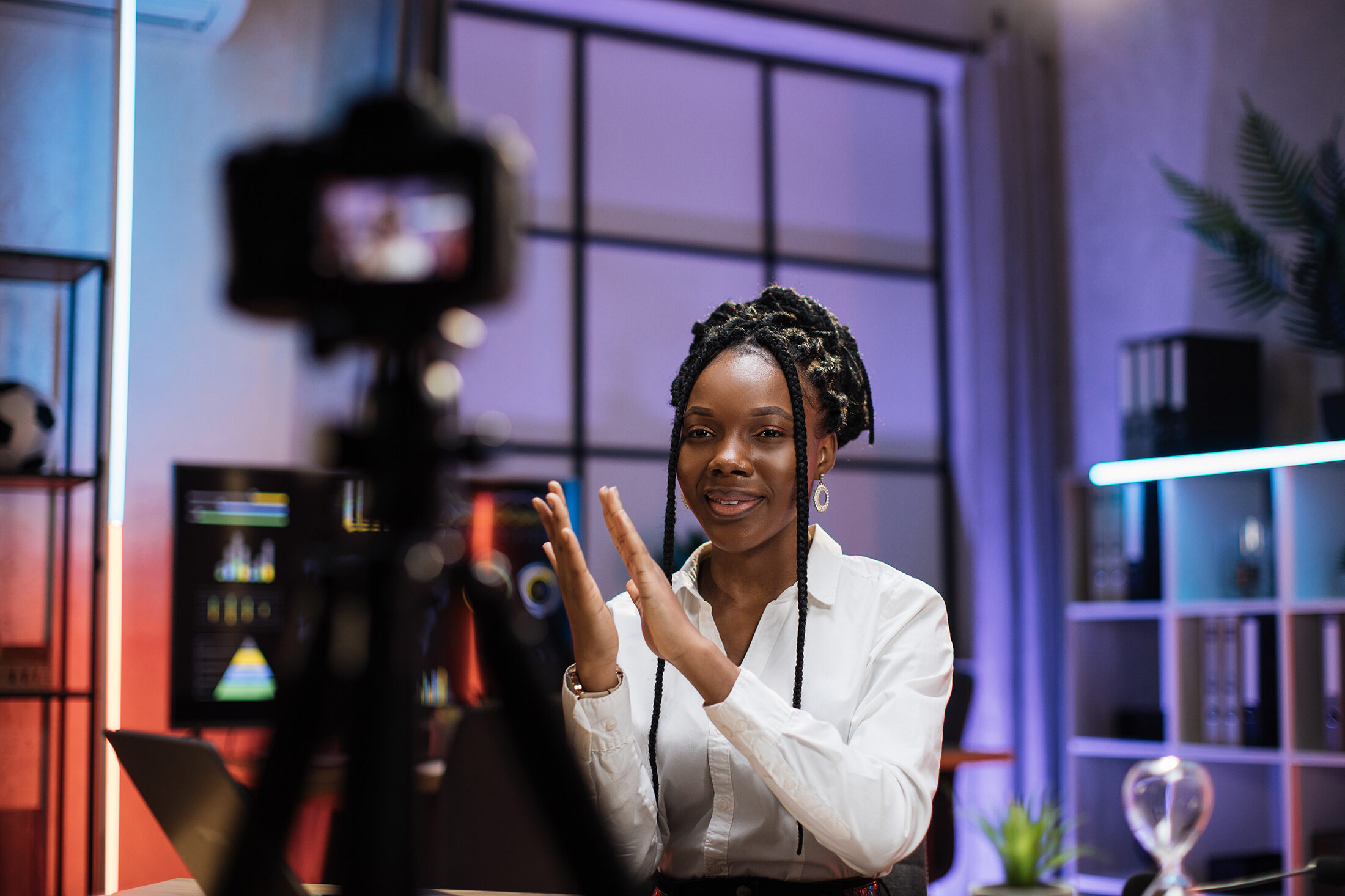 Woman in studio recording a podcast production.